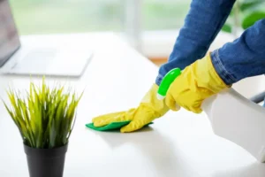 woman in uniform cleaning a table